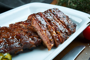 Close up view on tasty delicious bbq baby back ribs with barbecue sauce. Classical american Barbecued Pork