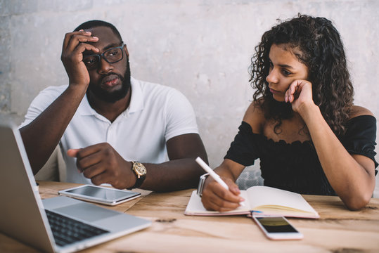 Pensive Diverse Couple Solving Problem Using Laptop