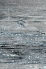 Old cracked boards with peeling blue paint. Natural grunge wood texture for your design close up. Village background