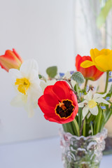 Spring bouquet with yellow tulips, and daffodils. Fresh flowers in a vase.Mothers day card .Women's Day, Birthday Present Background. Floral greeting card .