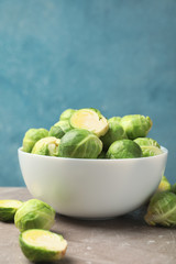 Bowl with brussels sprout on grey table, space for text