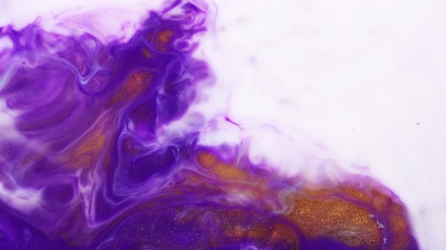 Fluid art painting with slow motion. Abstract texture artwork. Liquid background forms design. Psychedelic background with acrylic spreading paint. Purple, gold and white trend backdrop