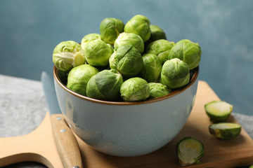 Composition with bowl of brussels sprout on grey table, close up