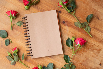 Beautiful flowers on the wooden table with notebook. The work of the florist. Flower delivery