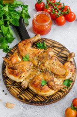 Tobacco chicken, a traditional dish of Georgian cuisine fried chicken with garlic and pepper. Vertical orientation. Close up.