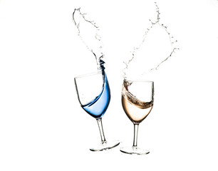 Two glasses crashing and spilling the liquid from inside