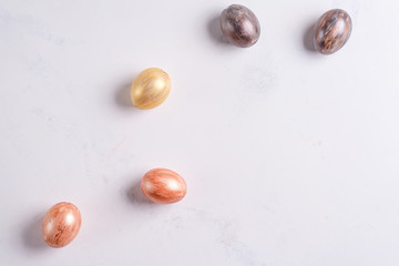 Beautiful Easter silver and gold eggs on marble background
