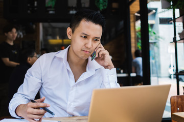 Upset freelancer calling cellphone in coffee shop