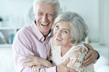 Portrait of cheerful senior couple at home