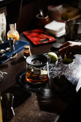 bartender makes original tea with cinnamon and apples