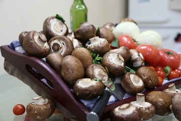 Still life from products: mushrooms, tomatoes small and large, onions view from above