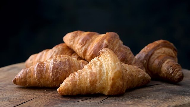 freshly baked croissants on old wooden table