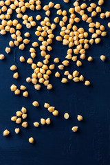 Chickpeas on a dark blue concrete background