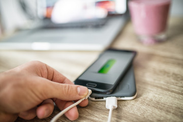 Man put his phone on power bank