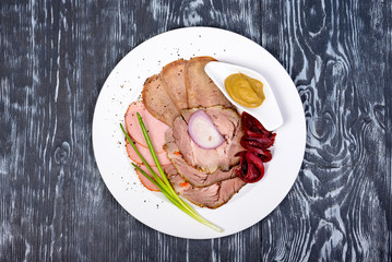 snack of slices of ham, beef tongue, mustard and horseradish
