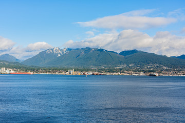 Vancouver, British Columbia, Canada - December, 2019 - Mountain View with clouds in a Beautiful blue sky day.