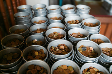 coins in the temple of the reclining buddha