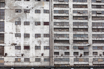Old industrial warehouse building facade with many small windows in Gdansk, Poland