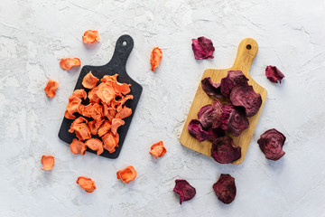 Carrot chips on the boards on a gray background. Horizontal orientation, top view.