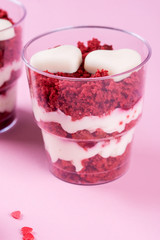Delicious and beautiful dessert, red velvet in cups. Hearts of white chocolate. Valentine's Day.