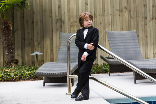 6 year old boy wearing formal attire standing by pool,St Simon's Island
