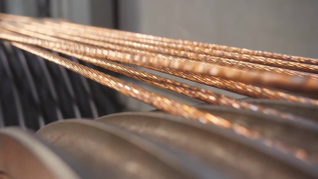 Production of copper cable. Rotating shafts with copper wire.