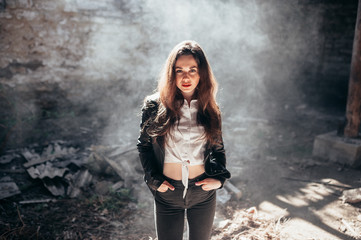 Brunette girl with red lipstick in the smoke.