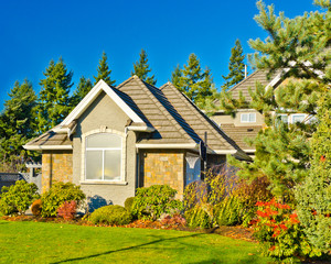 Fototapeta na wymiar Entrance of a house with nice outdoor landscape over blue sky
