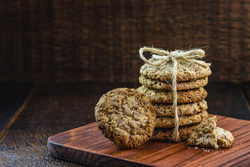 Whole grain cookies with cereals, dried fruits and chocolate on old wooden table
