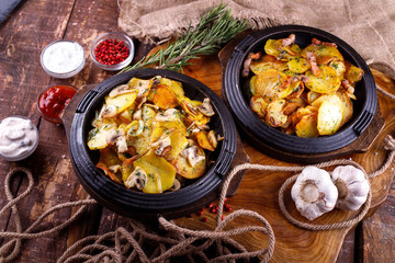 Fried potatoes with meat on a baking sheet