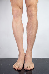 Crop man with shaved and hairy legs