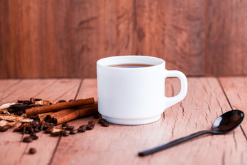 Fragrant natural custard coffee with cinnamon sticks, dried mushrooms, on a wooden background.