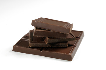 Broken chocolate bar is isolated on a white background. Close-up.