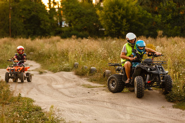 little boy with instructor on a quad bike