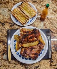 Baked pork ribs are a traditional meal of our Spanish gastronomic culture If you like baked meat this is one of the best ways to eat it with bread  