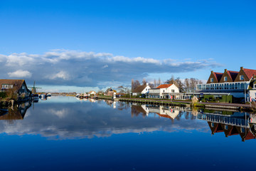 Reflections of clouds in the Ringvaart canal at the Lisserdijk in Lisse. On a sunny day in the Netherlands.