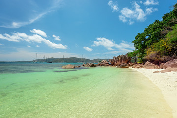 Tropical Island Curieuseat Seychelles - Sailing boats in background