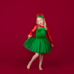 Kid dancer satisfied with concert outfit. Kids fashion. Kid fashionable green dress looks adorable. Clothes for ballroom dance. Ballroom dancewear fashion concept.
