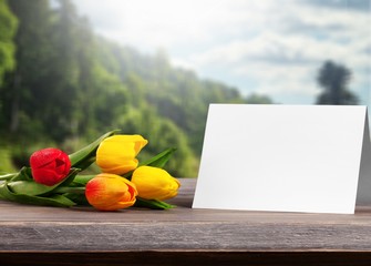 A fresh bouquet of tulips with a blank card
