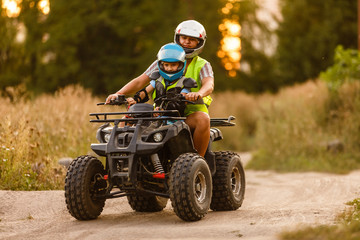 little boy with instructor on a quad bike