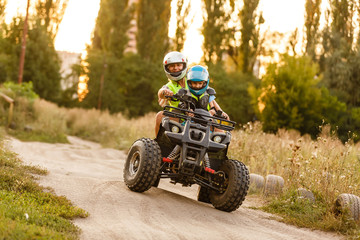 Fototapeta na wymiar little boy with instructor on a quad bike