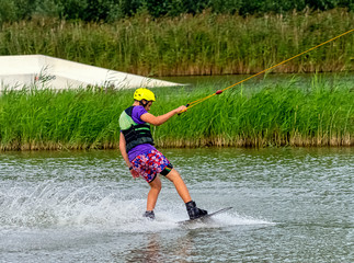 Teenager wakeboarding on a lake - Brwinow, Masovia, Poland