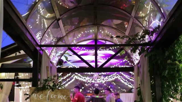 Group of people dancing in a  banquet hall for a wedding reception