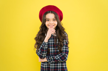 Fancy accessory. Child long curly hair wearing beret hat. Happy schoolgirl stylish uniform. Happy childhood concept. Happy smiling cheerful kid portrait. Small girl nice hairstyle. Fashion shop