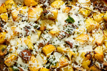 Baked potatoes with mushrooms and cheese with seasonings and herbs