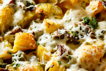 Baked potatoes with mushrooms and cheese with seasonings and herbs