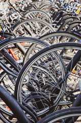 Detail of the bike wheels parked in Venlo, Limburg, Netherlands. Close up vertical photo. Dutch bicycle parking. City biking. Eco-friendly means of transport
