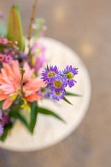 Bunch of colorful flowers in vase on marble table