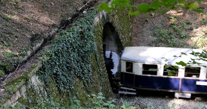 UDAPEST, HUNGARY - SEPT.28.2019: A steam train chugs through a tunnel in a mountainside