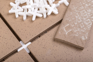White crosses used for laying gres tiles. Accessories and tools needed for construction workers.